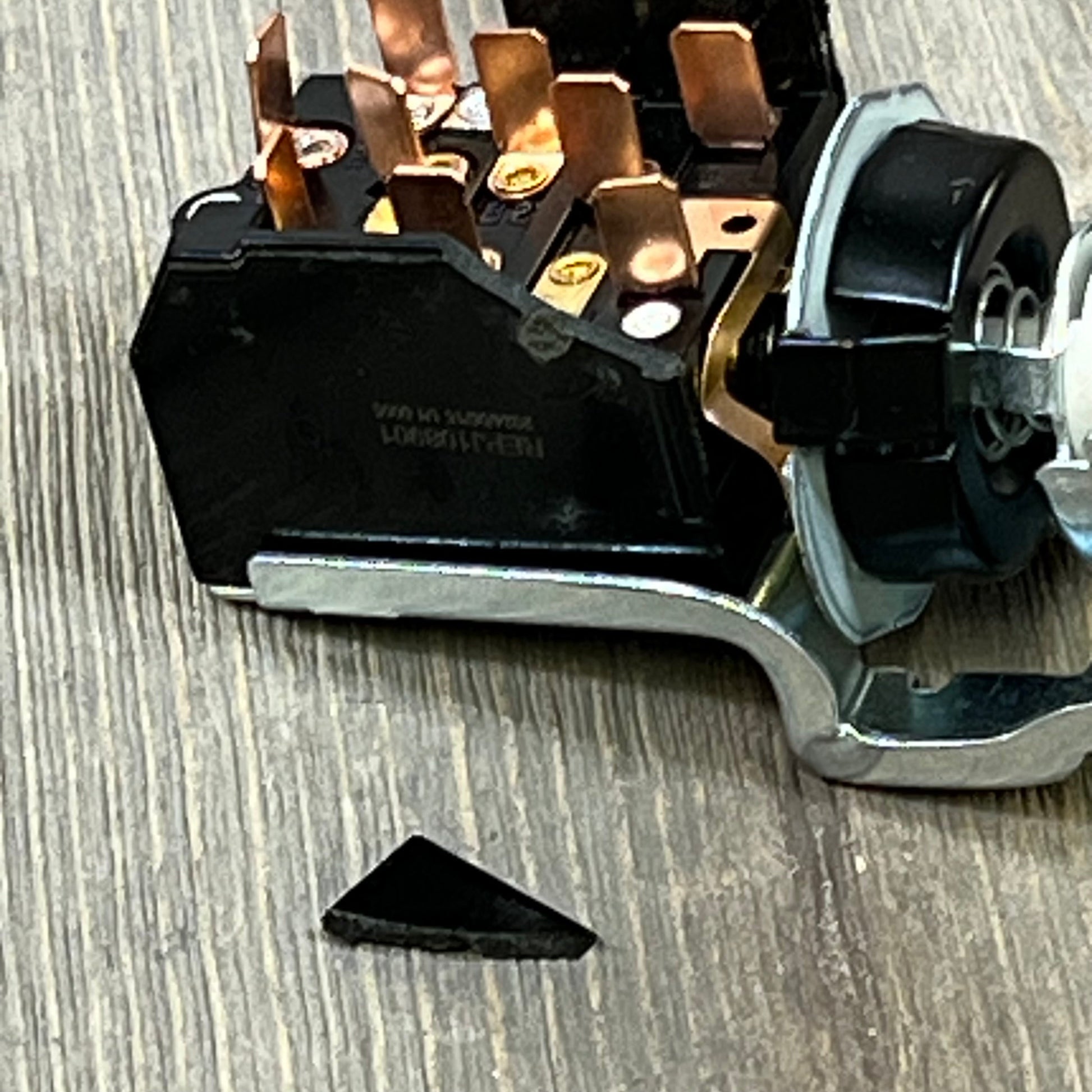 Close-up of Dodge Ram 1500/2500/3500 headlight switch, showing intricate copper connectors and durable black housing.
