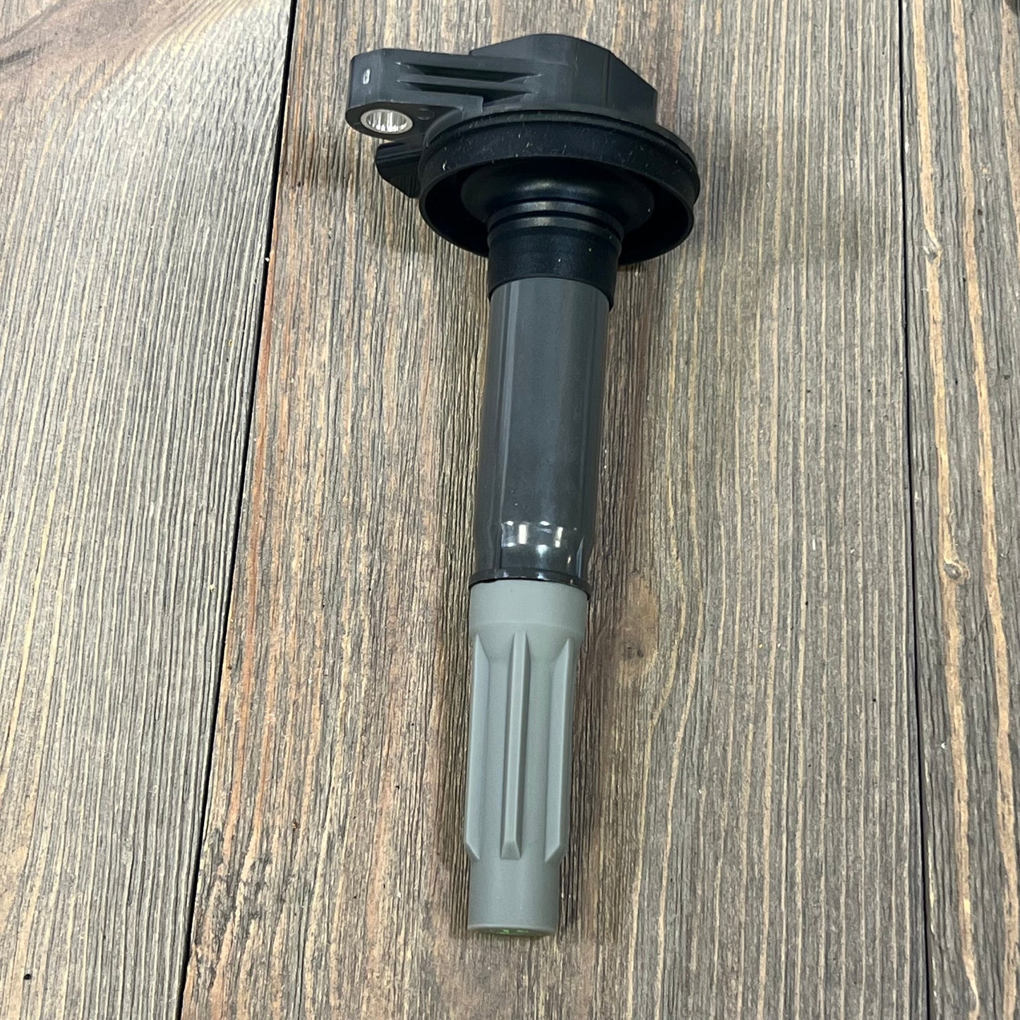 Ignition coil pack for V8 5.0L Ford F-150 and Mustang, compatible with 2016-2017 models, shown on wooden surface.