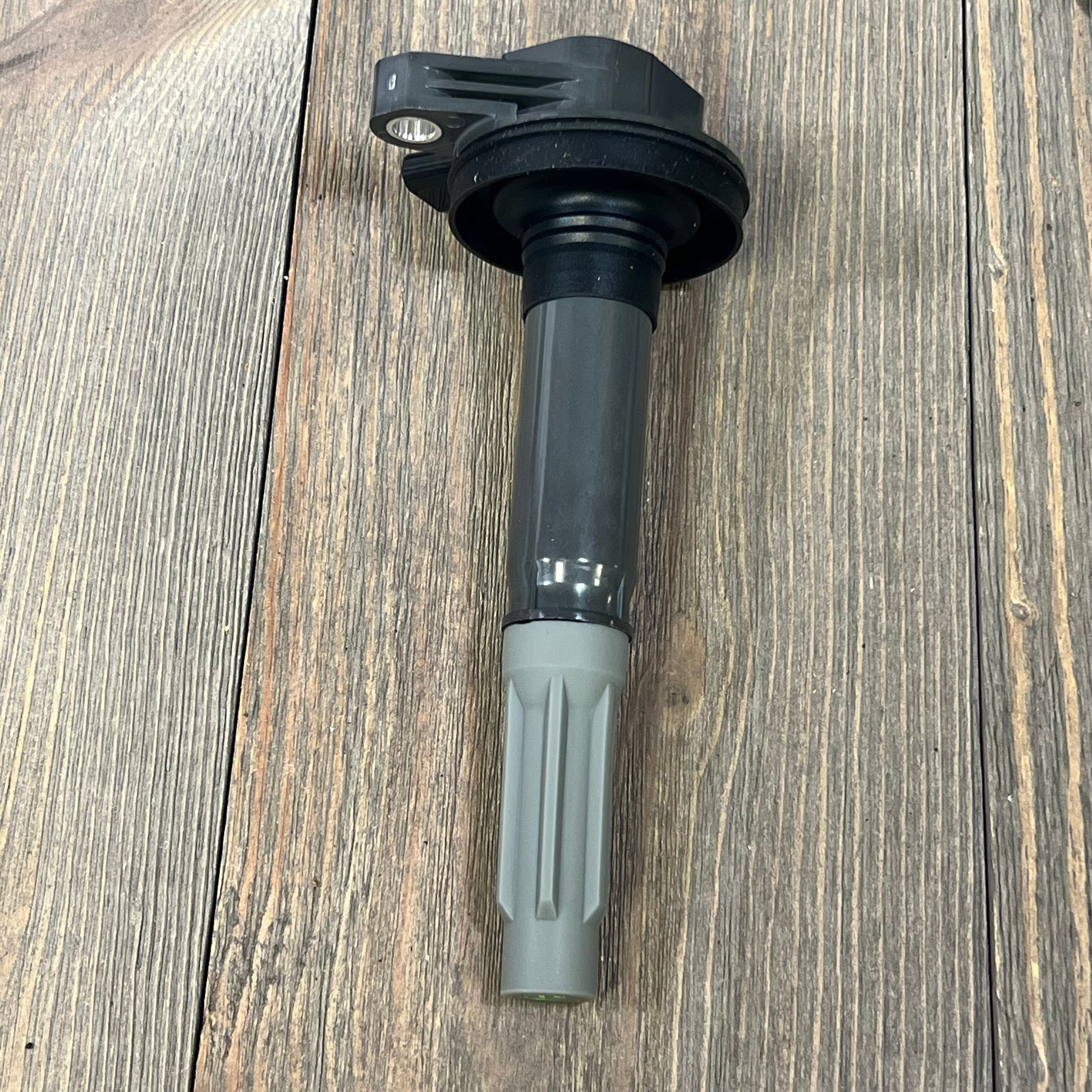 Ignition coil pack for V8 5.0L Ford F-150 and Mustang, compatible with 2016-2017 models, shown on wooden surface.
