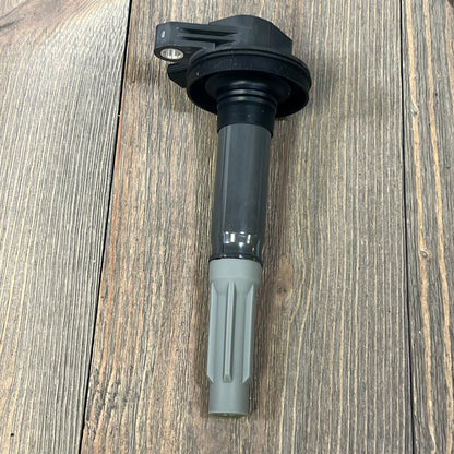 Ignition coil pack for V8 5.0L Ford F-150 and Mustang, compatible with 2016-2017 models, shown on wooden surface.