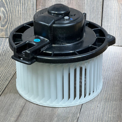 AC heater blower motor for 2000-2004 Toyota Avalon, model 700052, shown on a wooden surface.