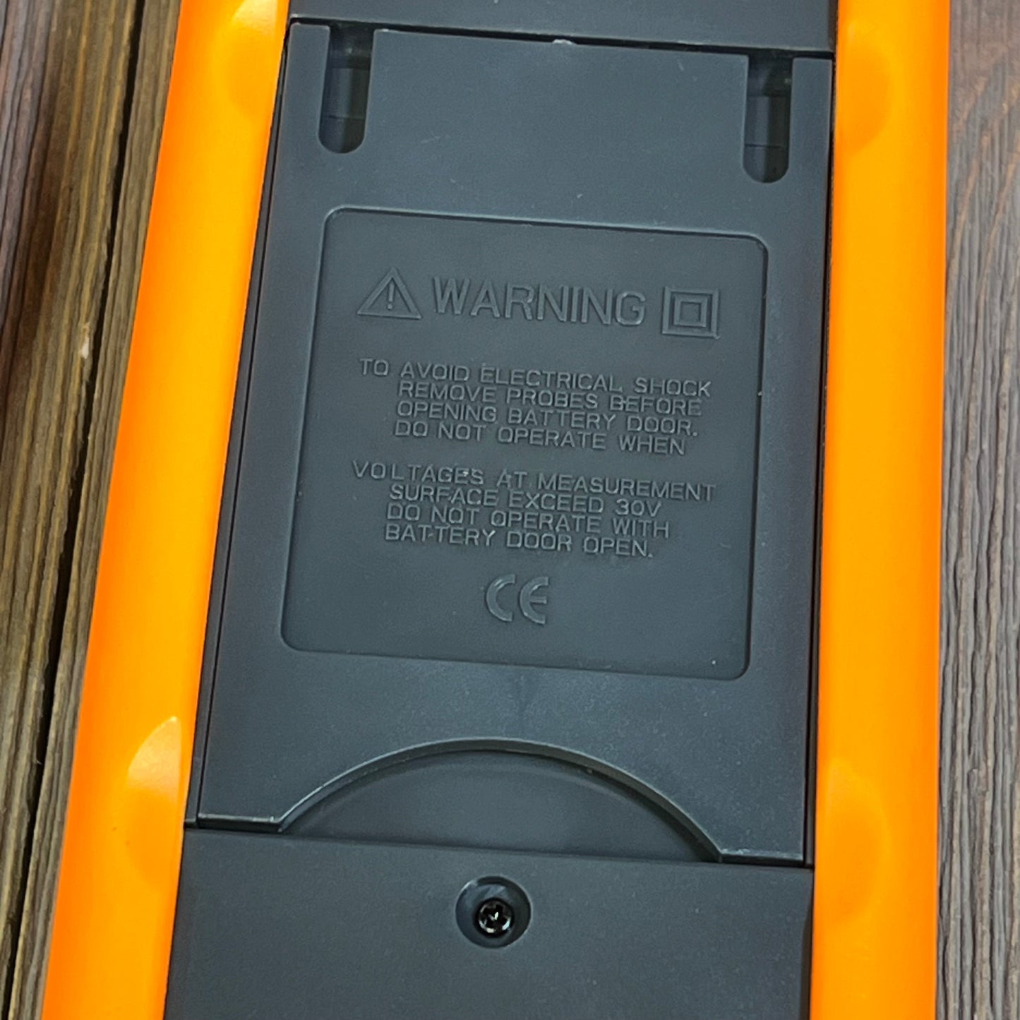 Back view of 1047108383-K Type Thermocouple Thermometer showing battery compartment and safety warnings.