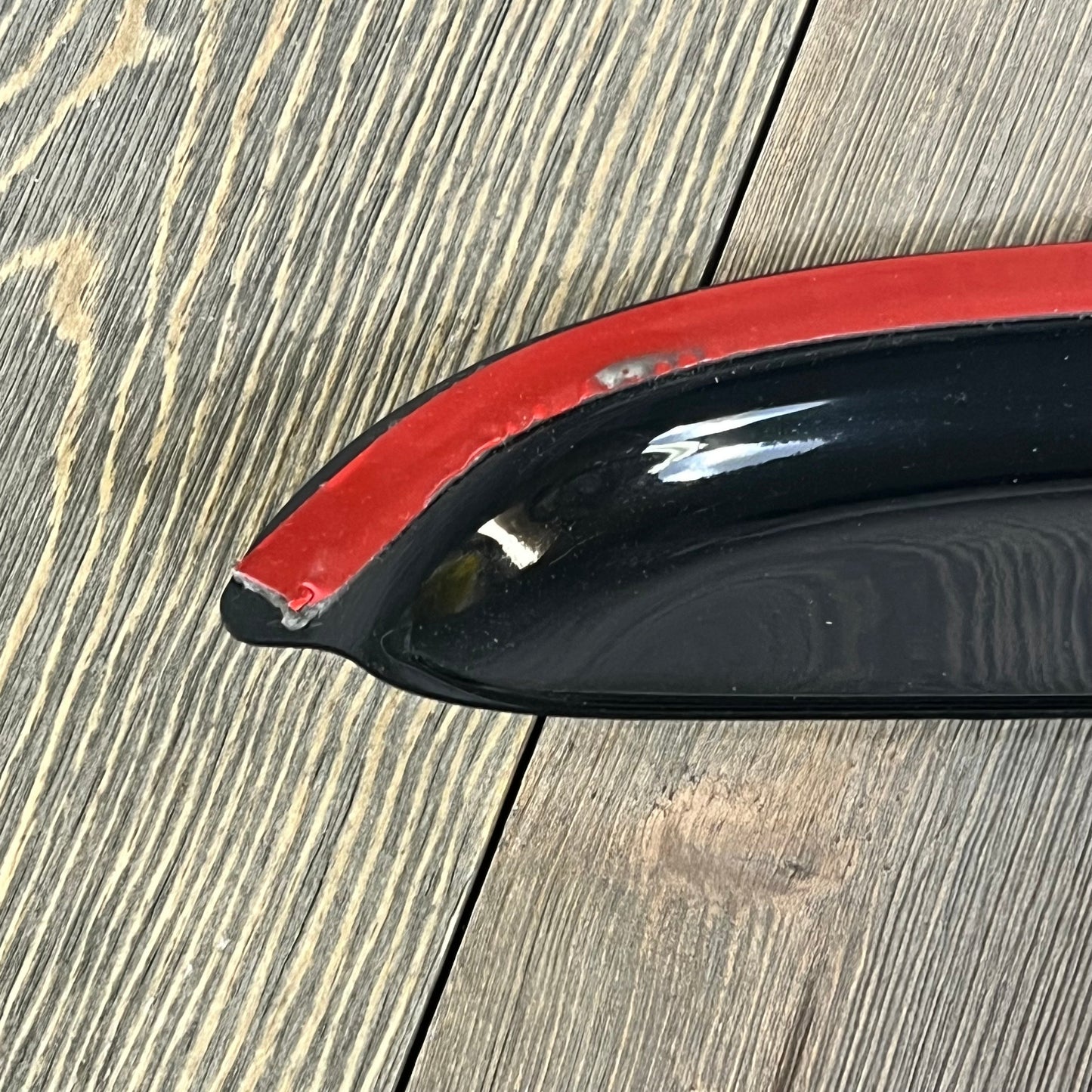 Lightronic dark smoke window visor with red trim, designed for 2005-2009 Ford Mustang Coupe, provides UV protection and durability.