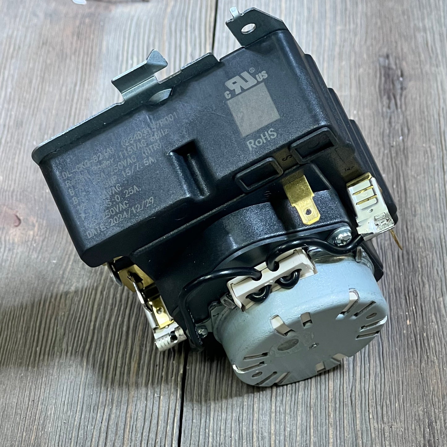 OEM Dryer Timer Replacement 1045787280-TMD1EM35, showcasing robust design and compatibility with GE models, on wooden surface.