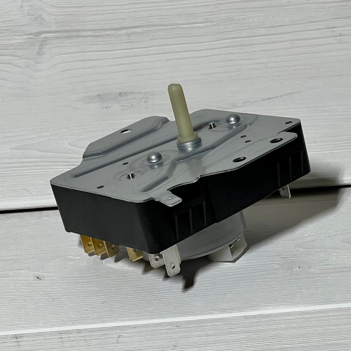 Dryer Timer 1048553842-W10185981, compatible with Whirlpool, Kenmore, Amana. OEM replacement part on wooden surface.