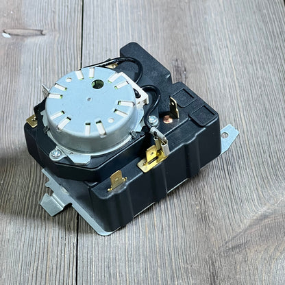 OEM dryer timer replacement for GE models shown on a wooden surface, featuring durable design for enhanced performance.