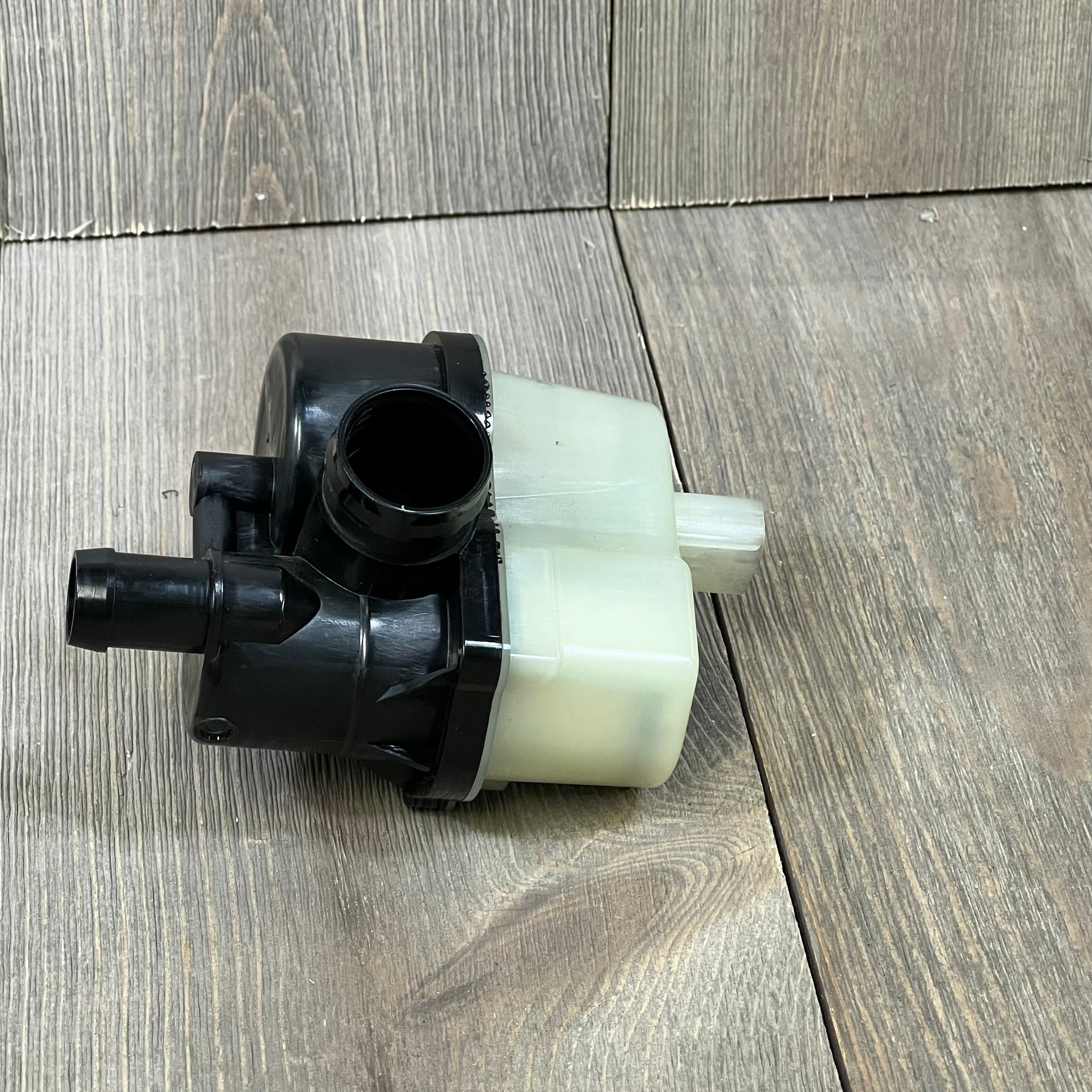 Fuel vapor leak detection pump for BMW models, featuring durable black and white design, essential for emissions system.