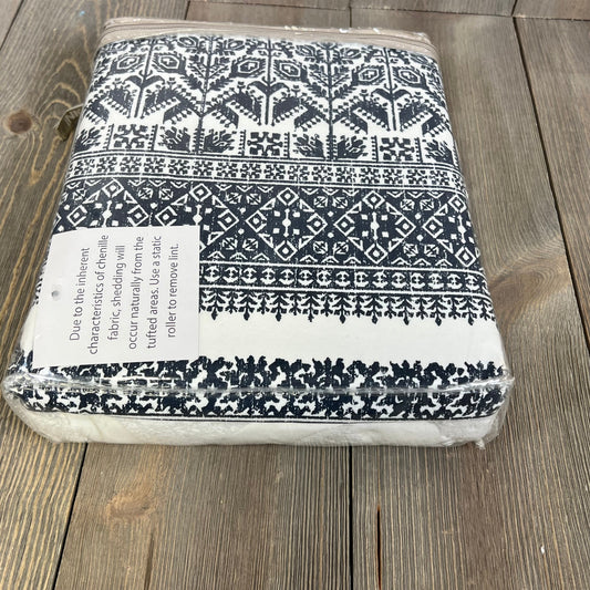 Navy and white boho curtain with tufted chenille design, packaged for display, ideal for bedroom or living room decor.