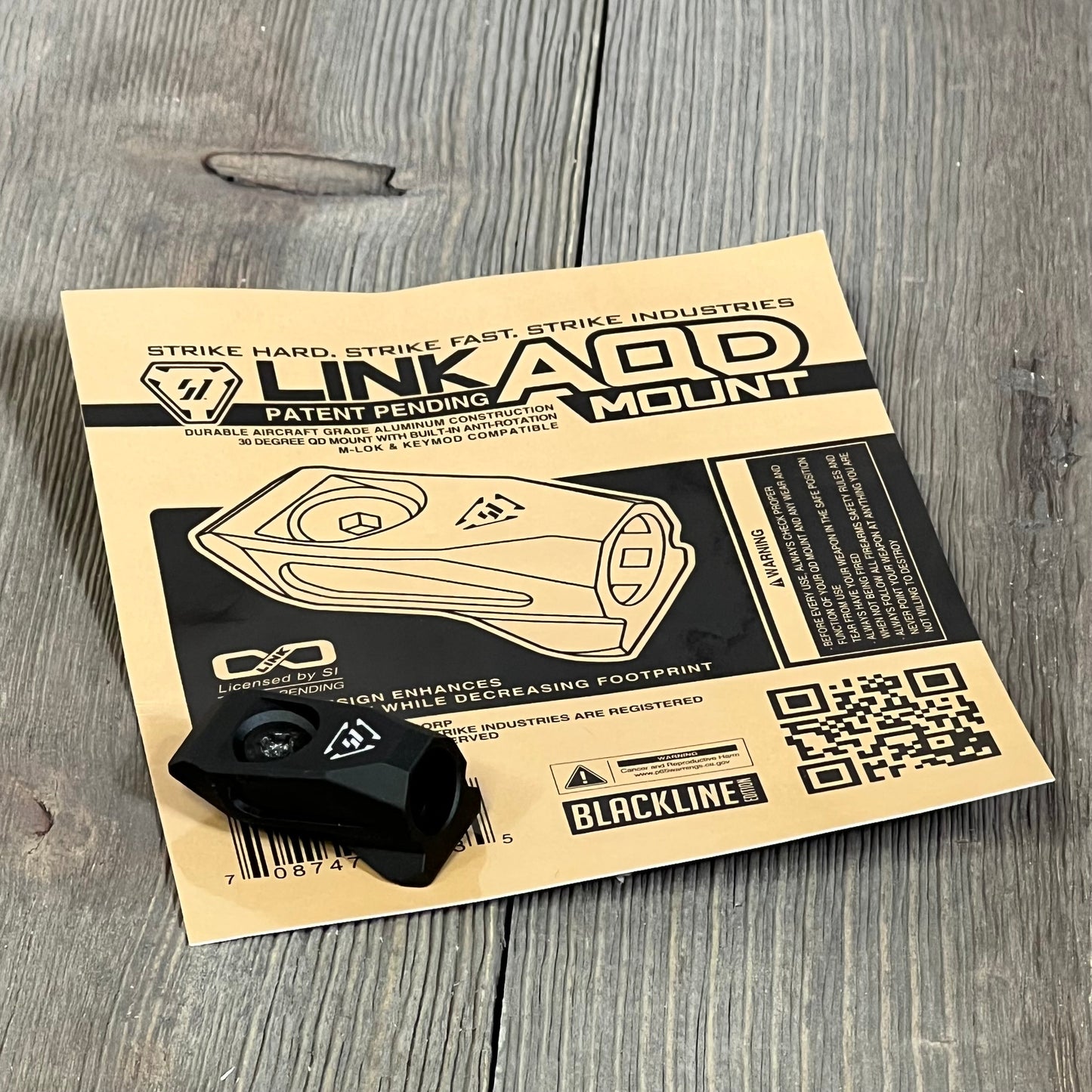 Strike Link Angled QD Mount BLK 1047052939 with packaging, featuring durable aluminum construction and versatile compatibility.