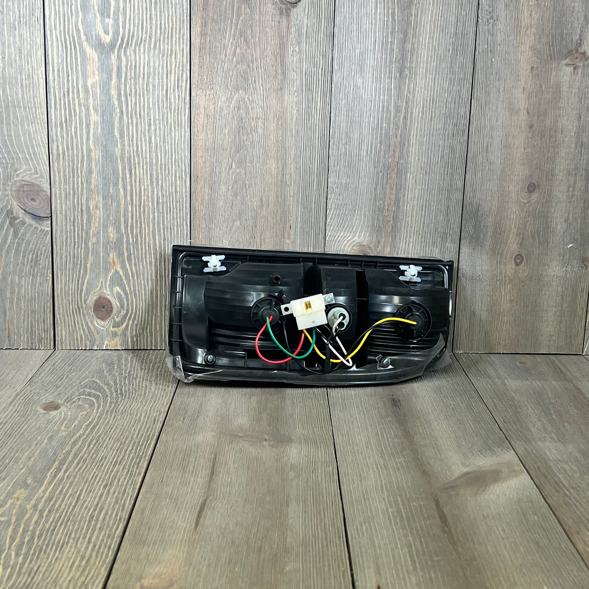 Rear view of GENRICS brake light replacement for 2001-2004 Toyota Tacoma, showing wiring and connectors.