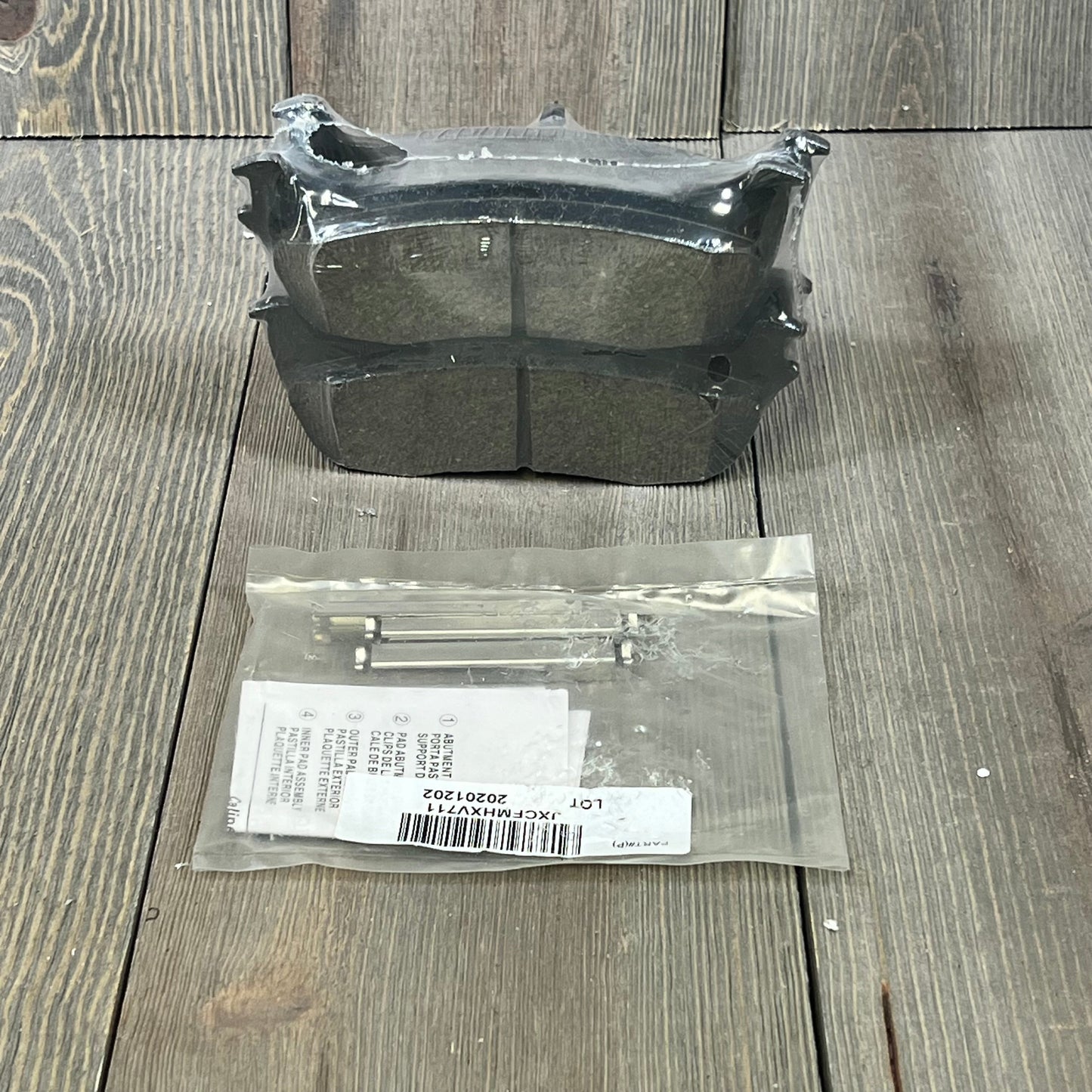 Wagner QuickStop ZD711 rear brake pad set for 2003 Ford F-150, includes accessories, displayed on wood surface.