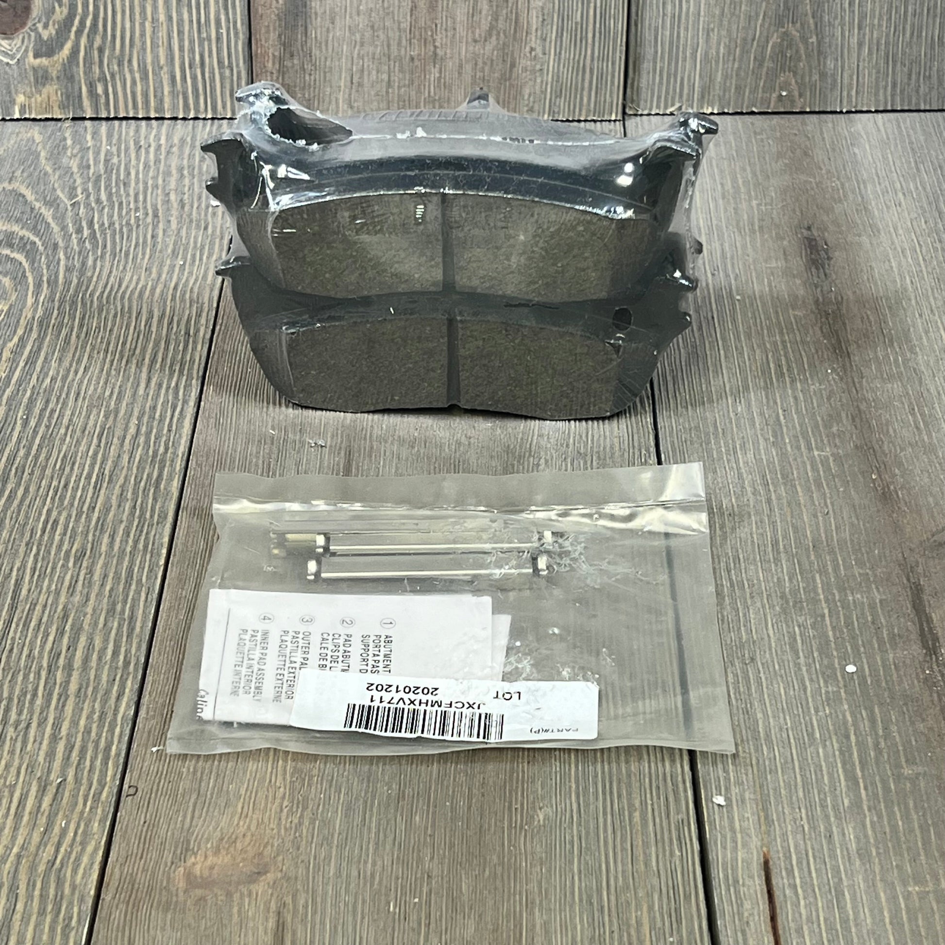 Wagner QuickStop ZD711 rear brake pad set for 2003 Ford F-150, includes accessories, displayed on wood surface.