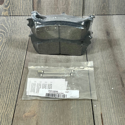 Wagner QuickStop ZD711 rear brake pad set for 2003 Ford F-150, includes accessories, displayed on wood surface.
