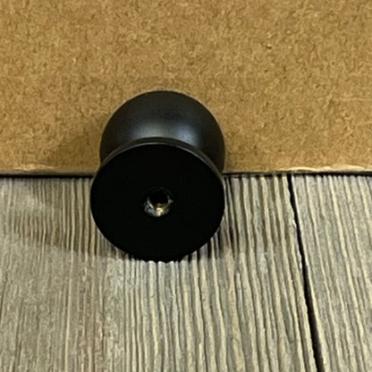 Matte black kitchen cabinet knob, 1 inch diameter, perfect for updating dresser drawers and doors with a sleek, modern look.