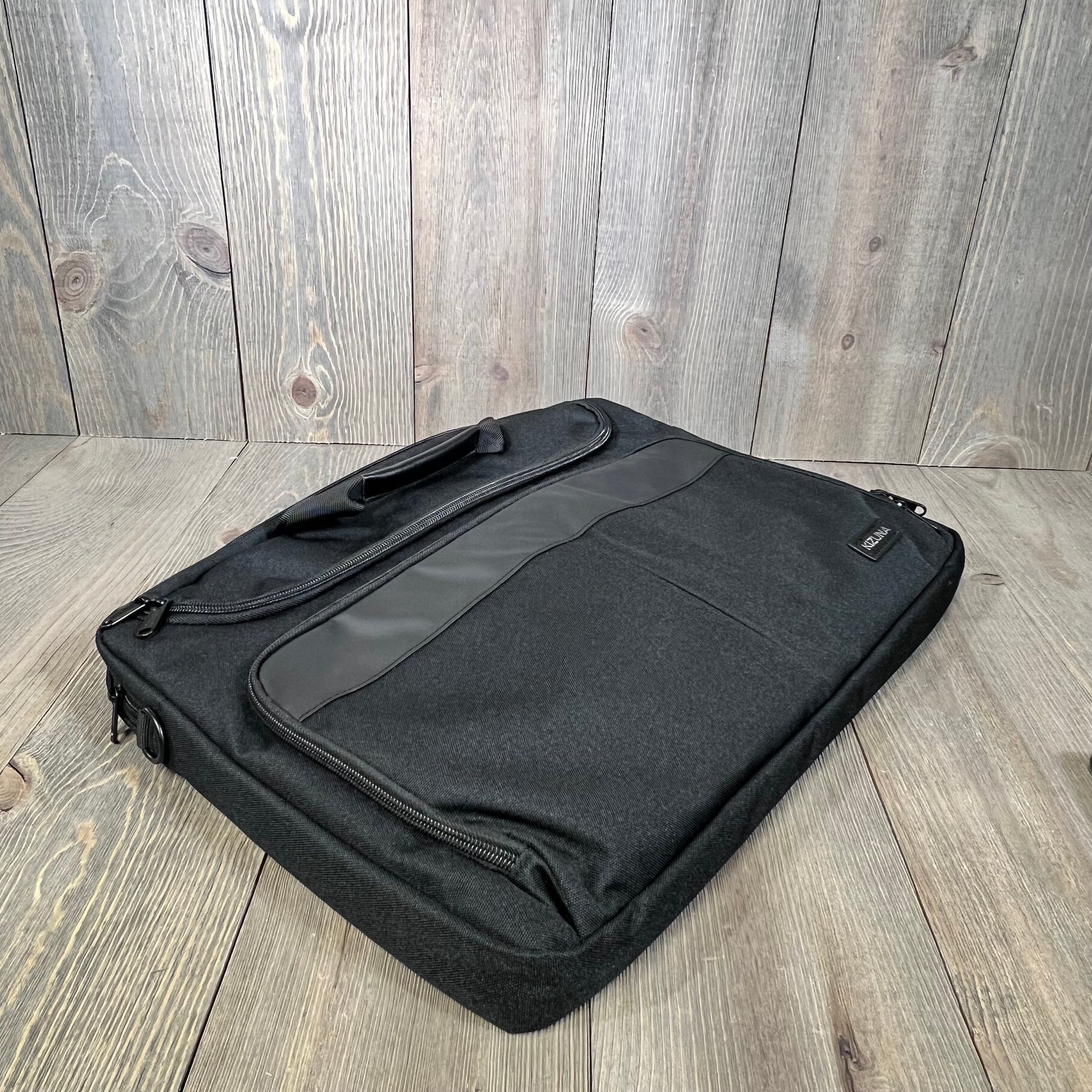Black KIZUNA laptop bag case for 17.3" laptops, featuring a sleek design and durable material, ideal for travel and work.