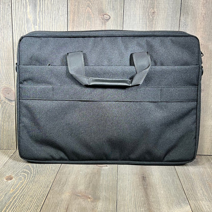 Black KIZUNA laptop bag case for 17-inch laptops, featuring a sleek design with durable handles on a wooden floor.