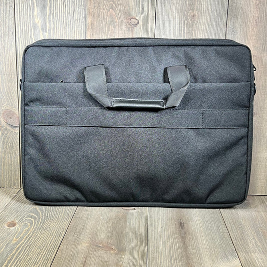 Black KIZUNA laptop bag case for 17-inch laptops, featuring a sleek design with durable handles on a wooden floor.
