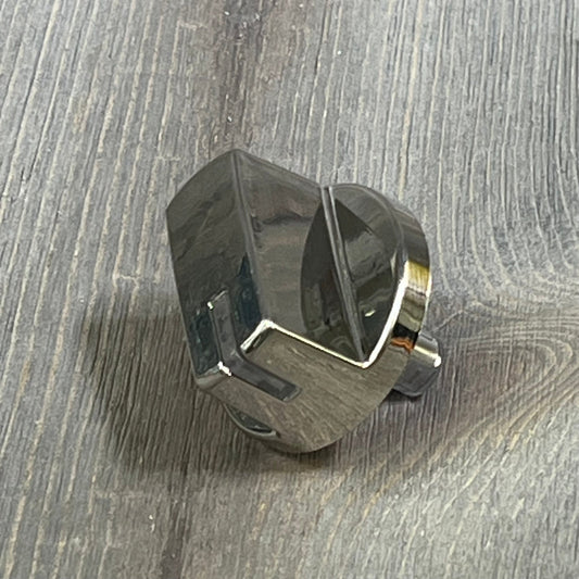 Chrome burner control dial knob replacement for LG gas stove, part AEZ73293801, shown on a wooden surface.