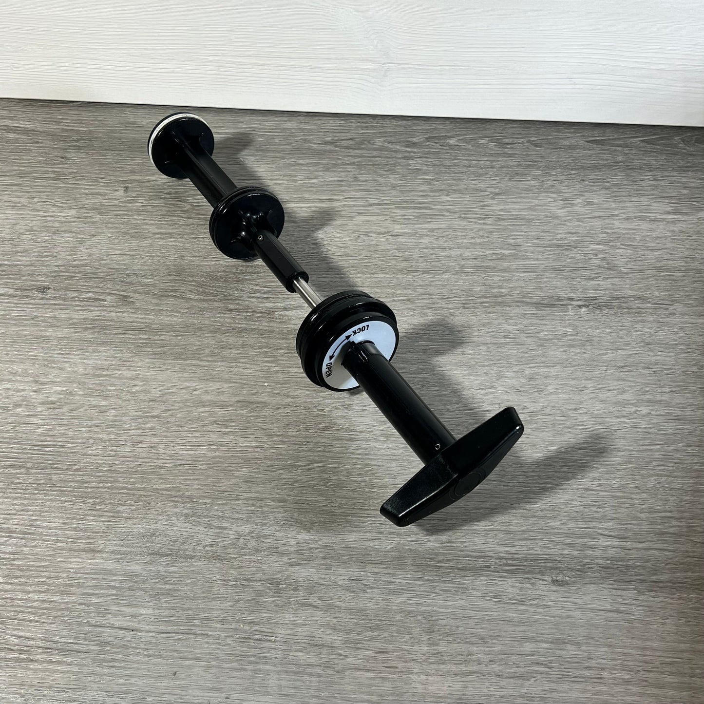 Black GUOJINJISM SPX0410BA handle and piston assembly on wooden floor, showcasing sleek design for Hayward slide valve.