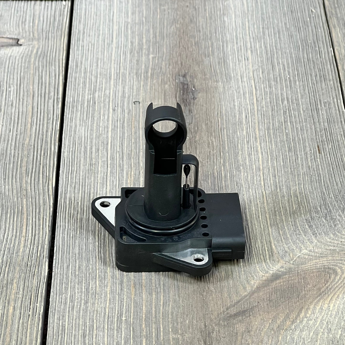 Mass Air Flow Sensor for Toyota Camry, Corolla, Highlander, and Lexus ES300/RX300, shown on a wooden surface.