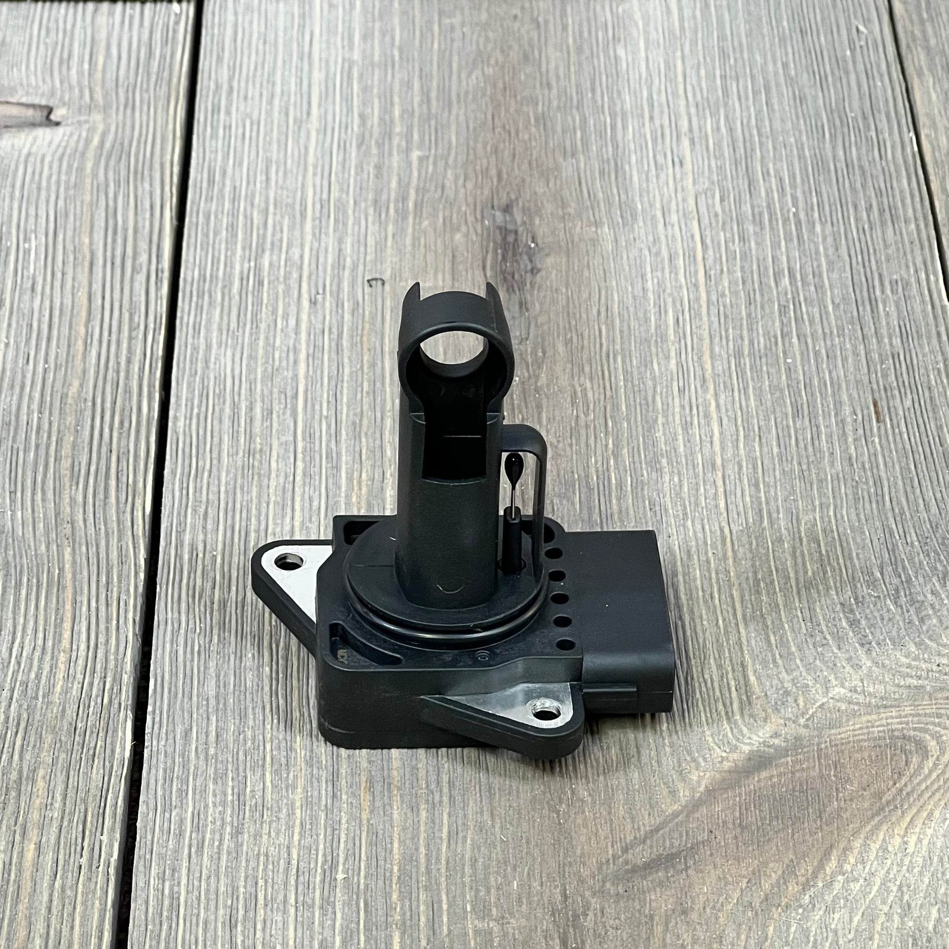 Mass Air Flow Sensor for Toyota Camry, Corolla, Highlander, and Lexus ES300/RX300, shown on a wooden surface.