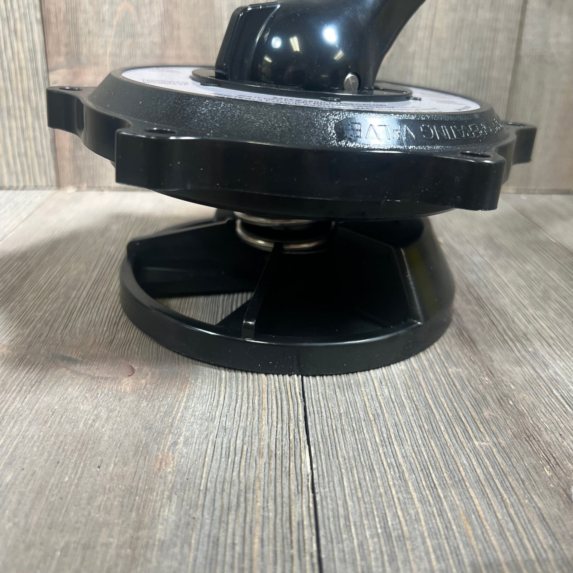 Black key cover and handle assembly for Hayward SP0710 valves on wooden surface.