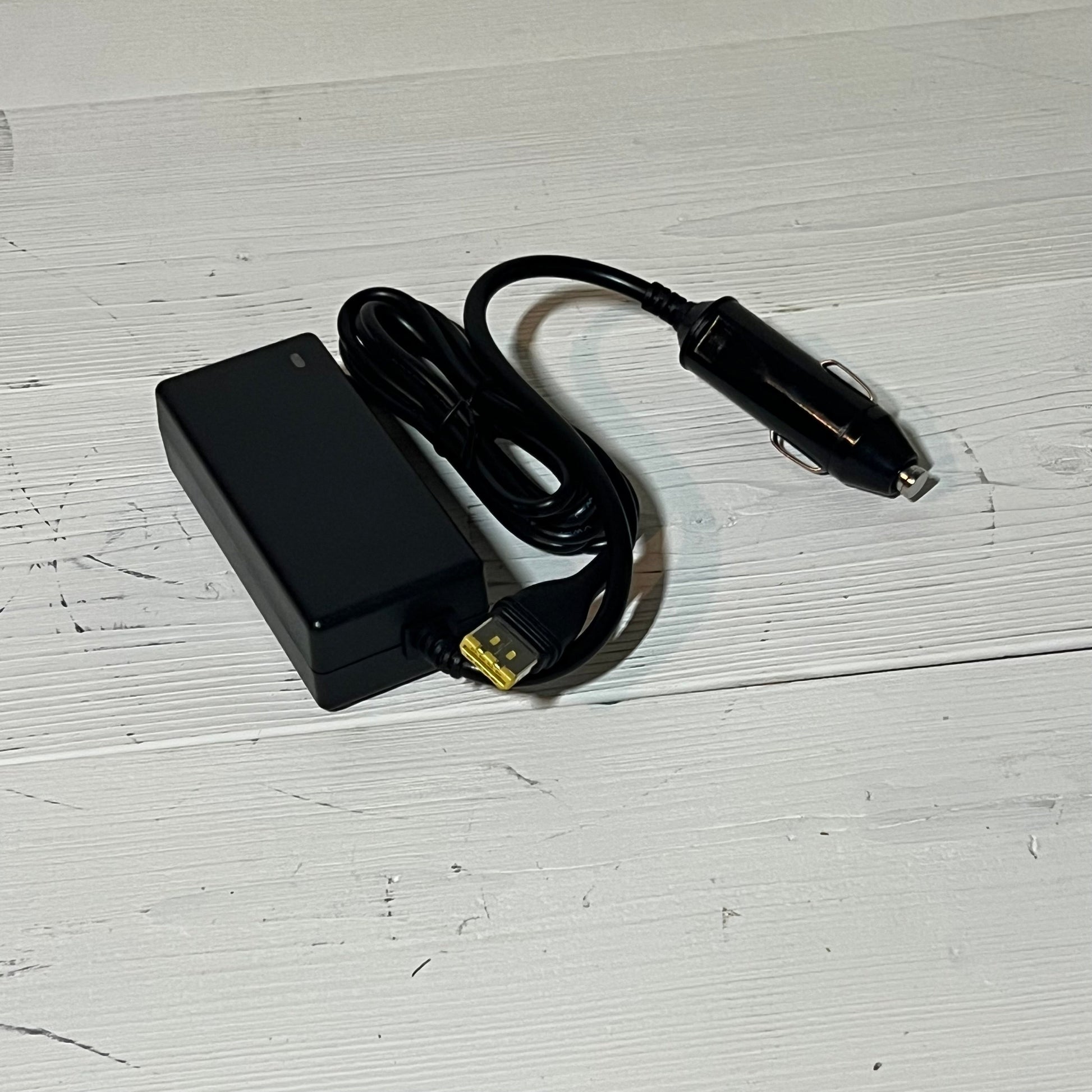 Black 12V car adapter for Resmed Airsense 11, featuring a long cord and sleek design, perfect for CPAP users on the go.