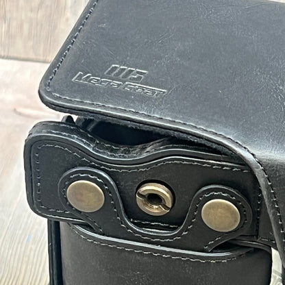 Close-up of MegaGear MG1942 black leather camera case, showing stitching and metal hardware, compatible with Nikon Z5.