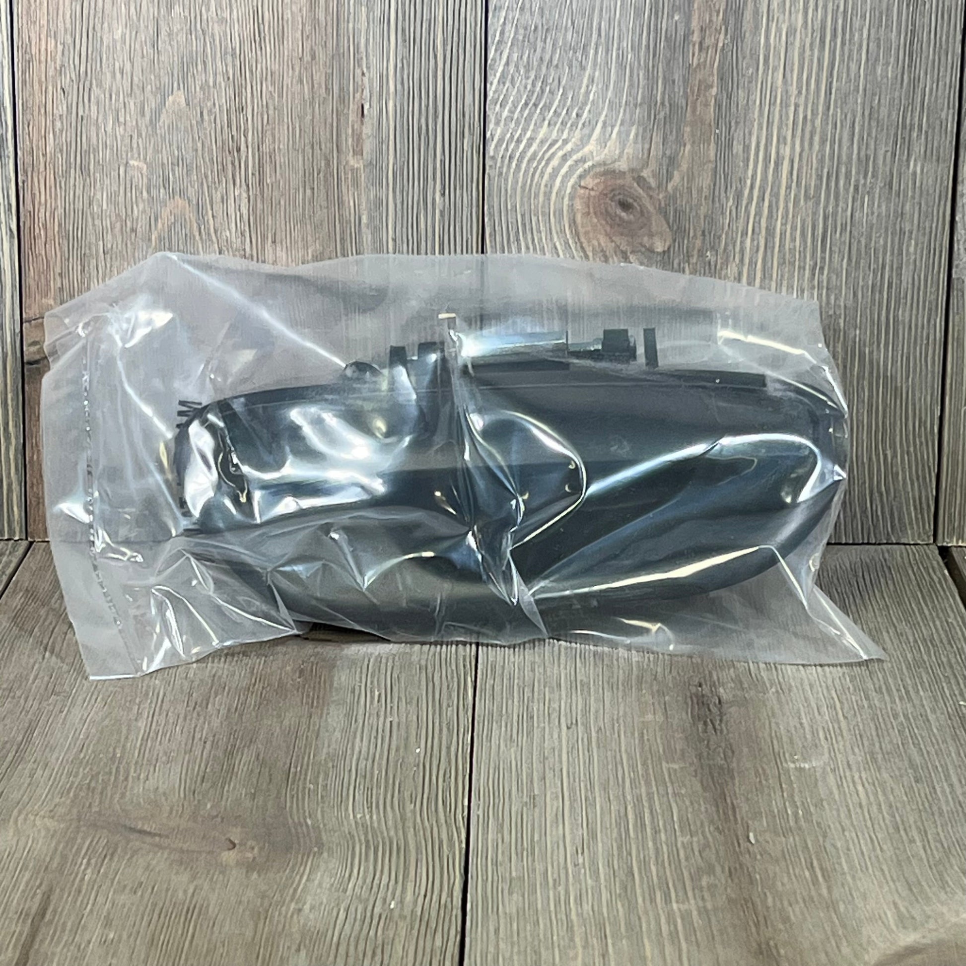 Textured black exterior door handle for Subaru, model 1047278253, packaged securely in plastic wrap.
