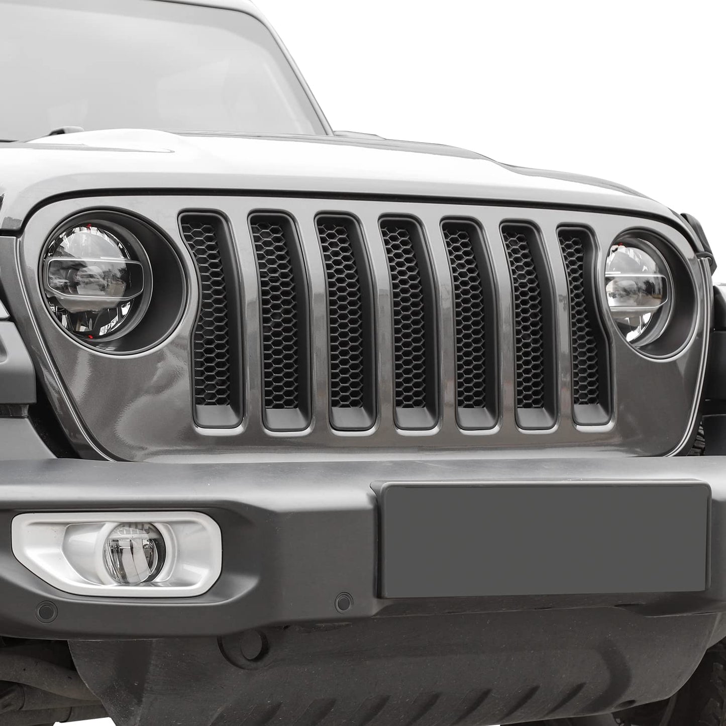 Matte black front grill inserts and headlight trim on Jeep Wrangler 2018-2023 JL, enhancing exterior style and protection.