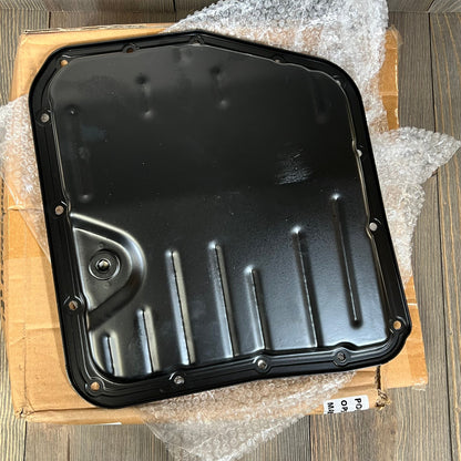 Premium black transmission oil pan with drain plug for Toyota Camry and Corolla, featuring durable 15 bolt holes.