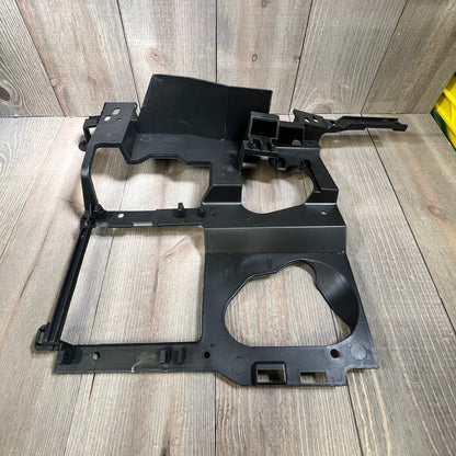 Black headlight bracket mounting panel for 1999-2006 Chevy Silverado, Suburban, Tahoe, GMC Sierra, Yukon driver side.