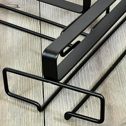 Black under-cabinet wine glass rack with sleek design for efficient kitchen storage. Durable and stylish stemware holder.