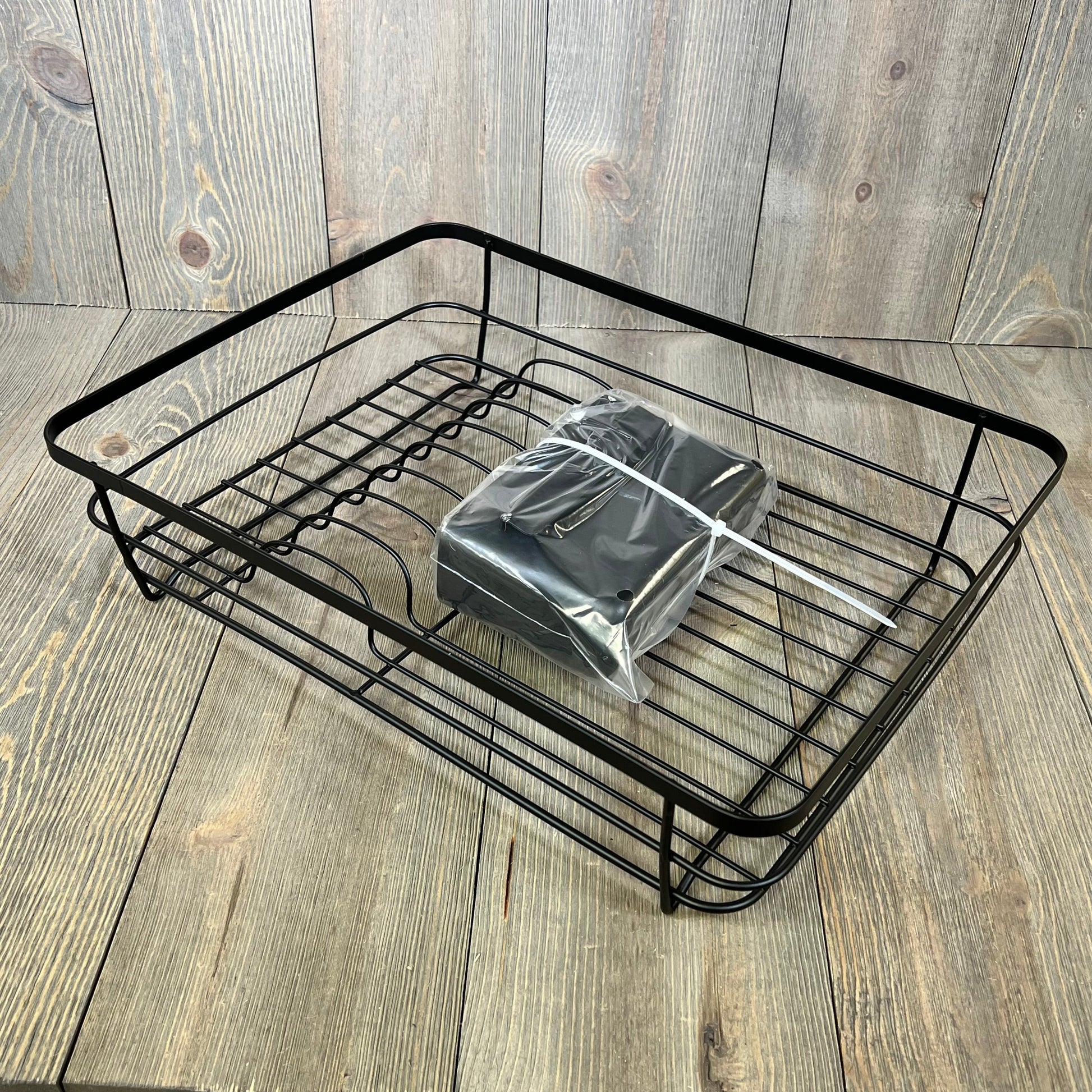 Space-saving Kitsure dish drying rack in black with cutlery holder, ideal for kitchen counters.
