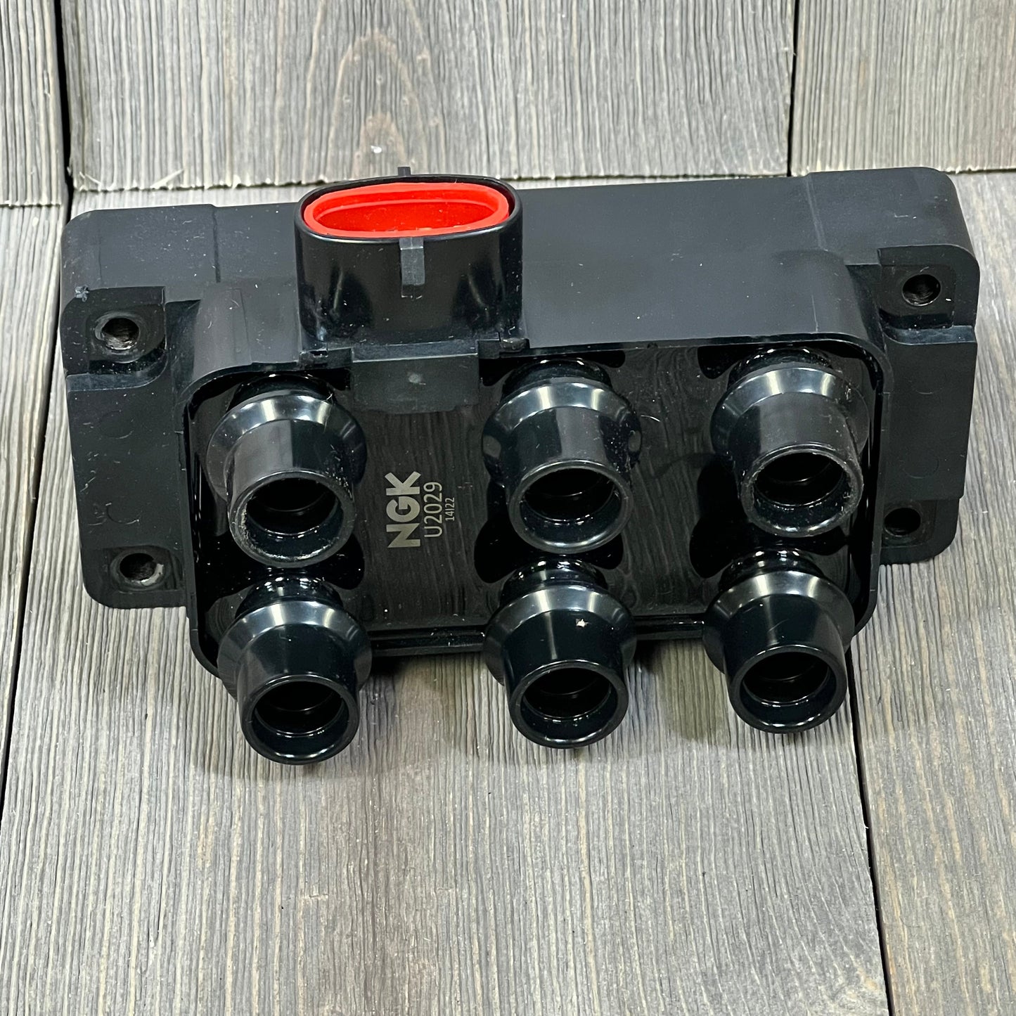 NGK U2029 ignition coil for distributorless systems, featuring a durable black casing and multiple connection points.