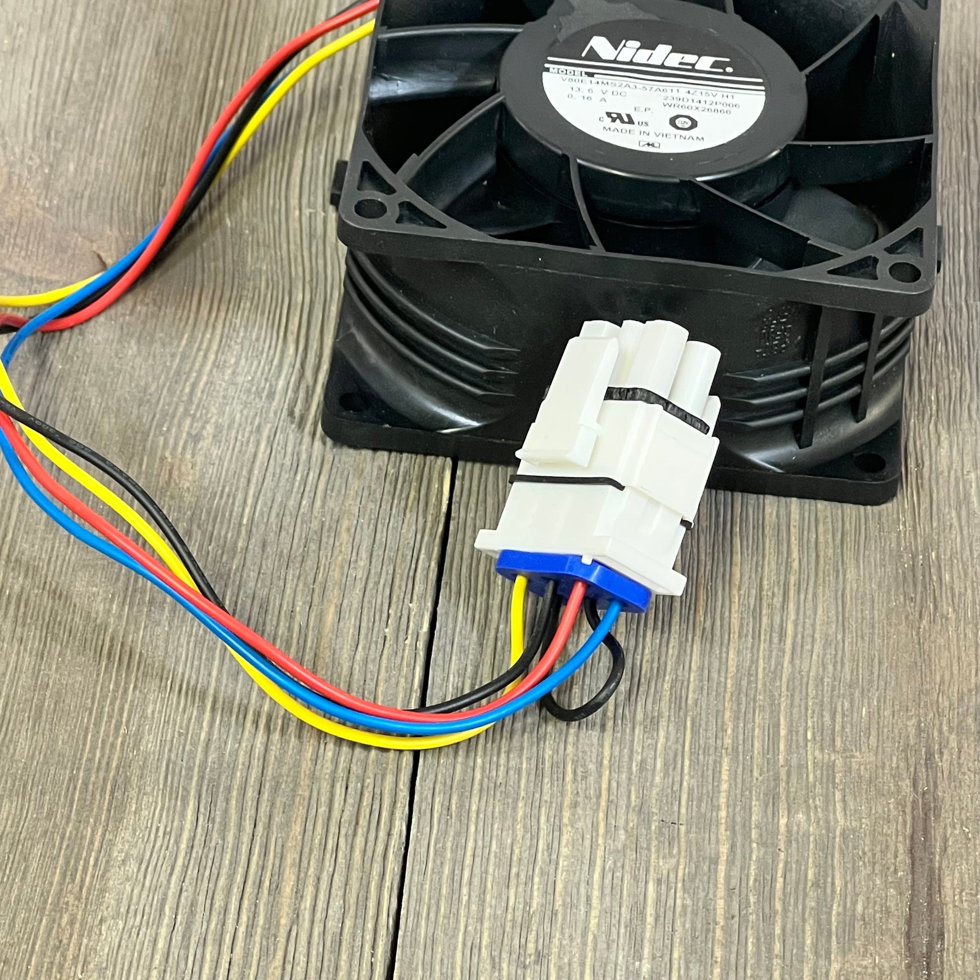 GE refrigerator evaporator fan motor WR60X26866 with colorful wires, ideal for cooling efficiency.