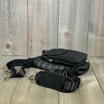 Black water bottle carrier bag with detachable shoulder strap and storage pouches, compatible with Stanley Cup.