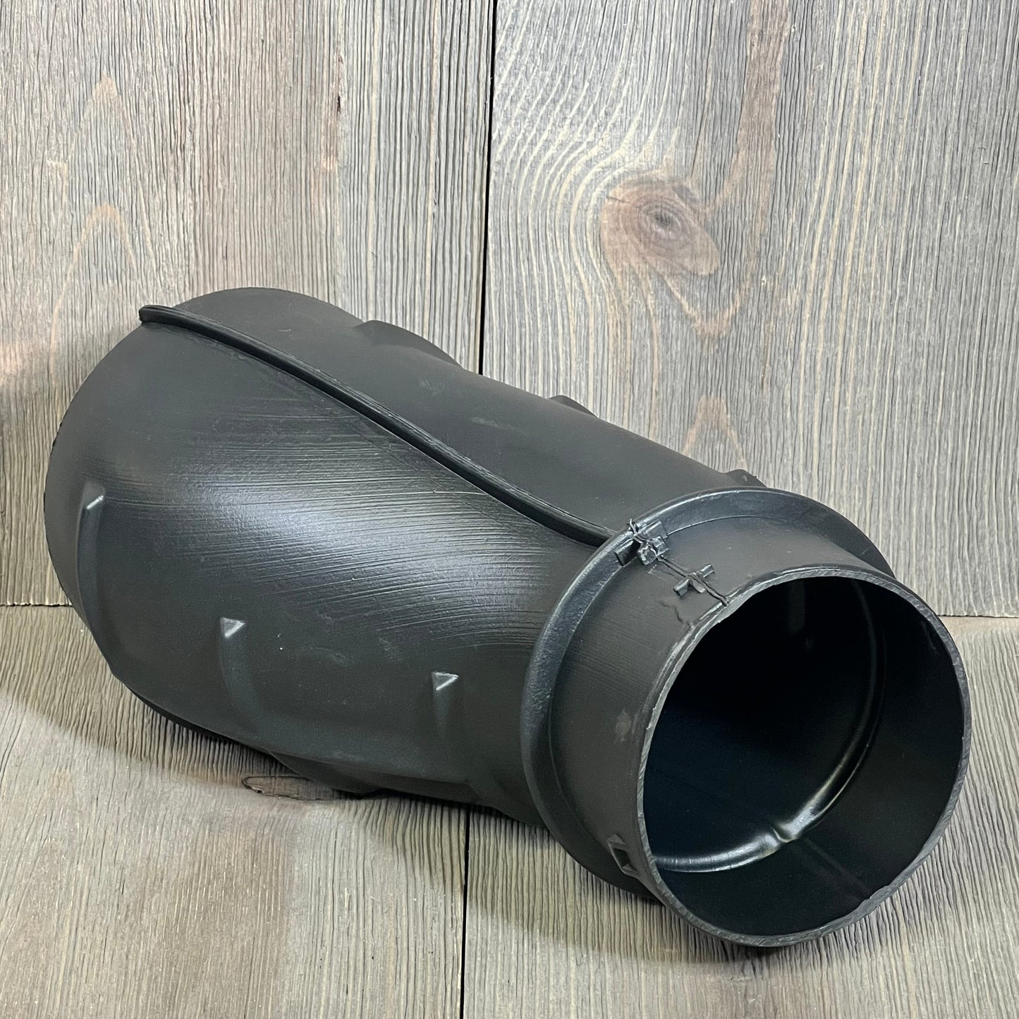 Black plastic air cleaner duct tube for 2015-2022 Dodge Challenger Hellcat SRT, part number 1047205795, on wood background.