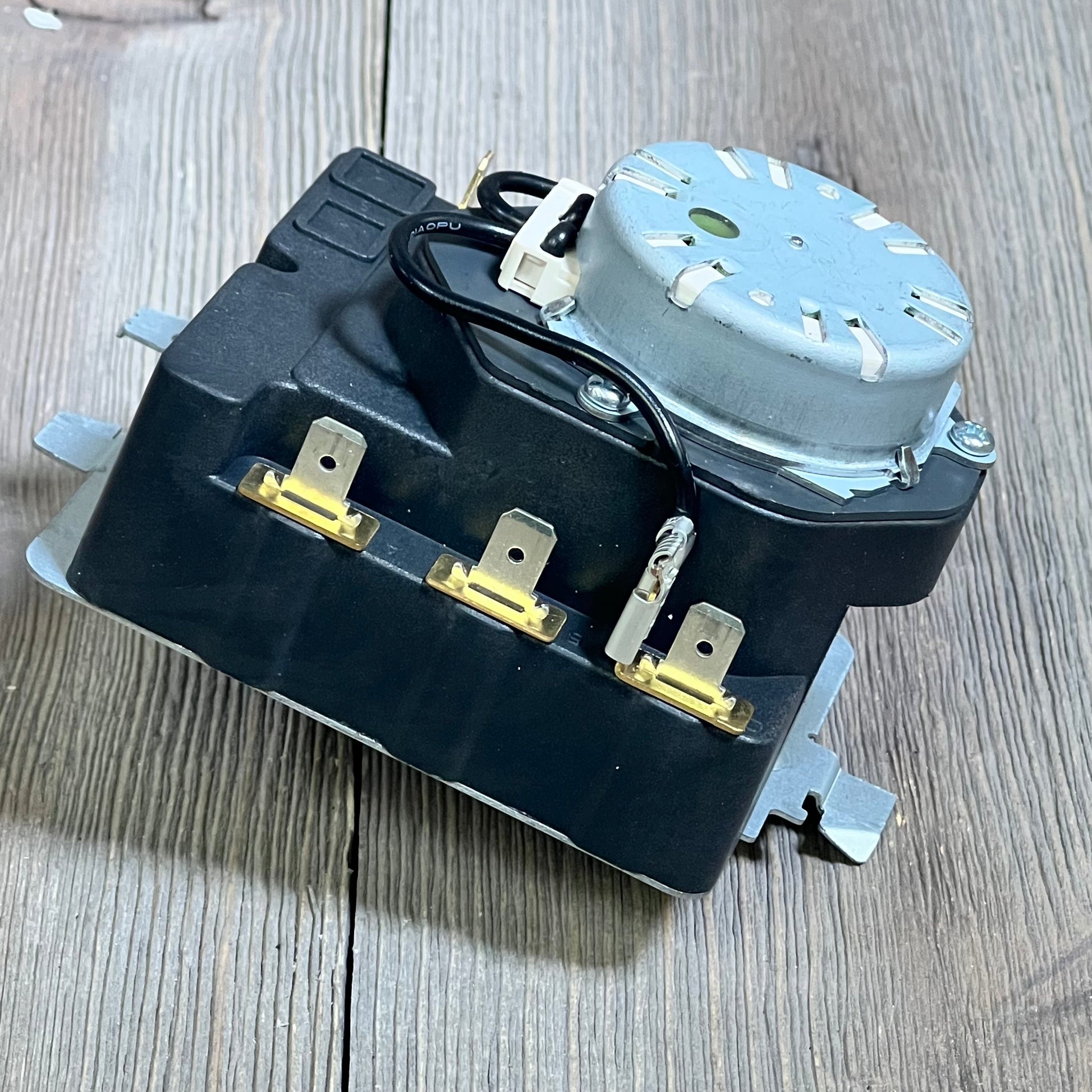 OEM dryer timer replacement for GE models, featuring upgraded design and enhanced performance, displayed on a wooden surface.