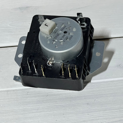 Dryer timer 1048553842-W10185981 with metal gear, compatible with Whirlpool and Kenmore, on white background.