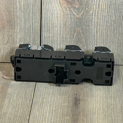 Black Motoforti power window switch for Ford vehicles, showcasing rear view with connector details on a wooden surface.