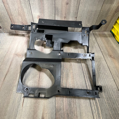 Black headlight bracket mounting panel for 1999-2006 Chevy Silverado, Suburban, Tahoe, GMC Sierra, Yukon driver and passenger sides.