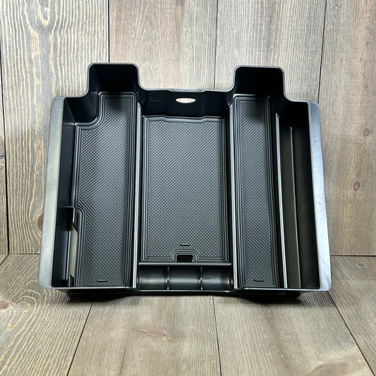 Black center console organizer compatible with Chevy Silverado and GMC Sierra, featuring multiple compartments for storage.
