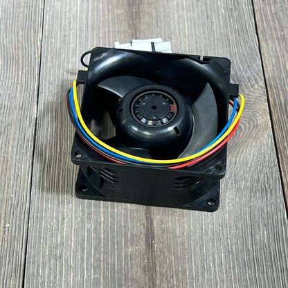 GE Appliances refrigerator evaporator fan motor WR60X26866 with colored wires on wooden surface.