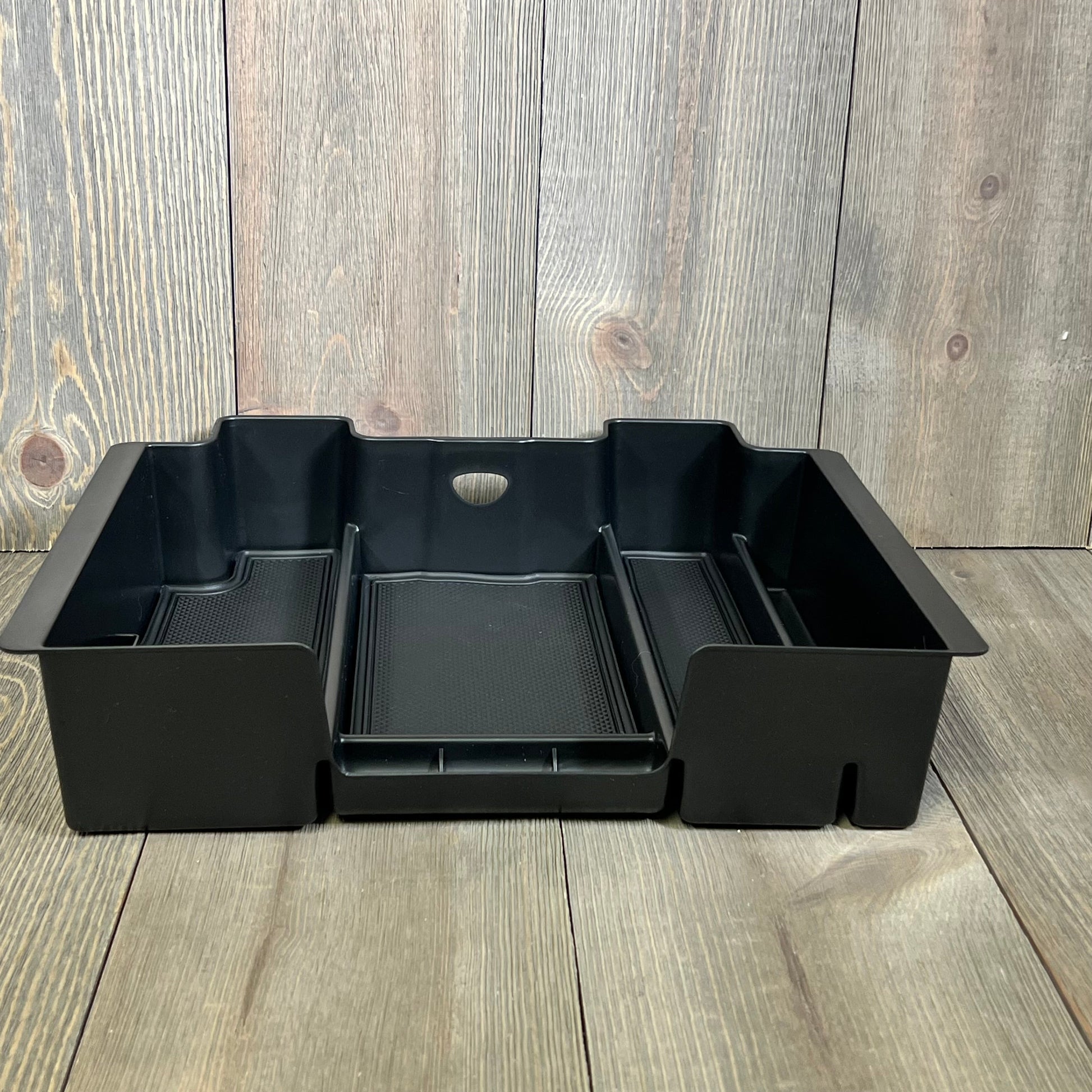 Black center console organizer for Chevy Silverado/GMC Sierra, designed for efficient armrest storage and easy access.