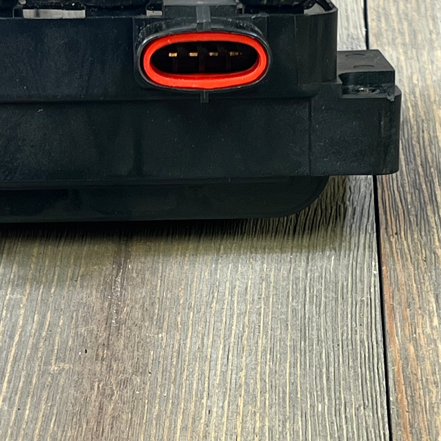 Close-up view of NGK U2029 (48806) ignition coil connector for distributorless ignition system, highlighting red seal.