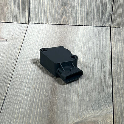 Black TPS Throttle Position Sensor Kit for Ford, Volvo, International Navistar Trucks on wooden surface.