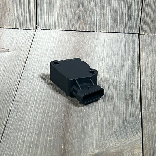 Black TPS Throttle Position Sensor Kit for Ford, Volvo, International Navistar Trucks on wooden surface.