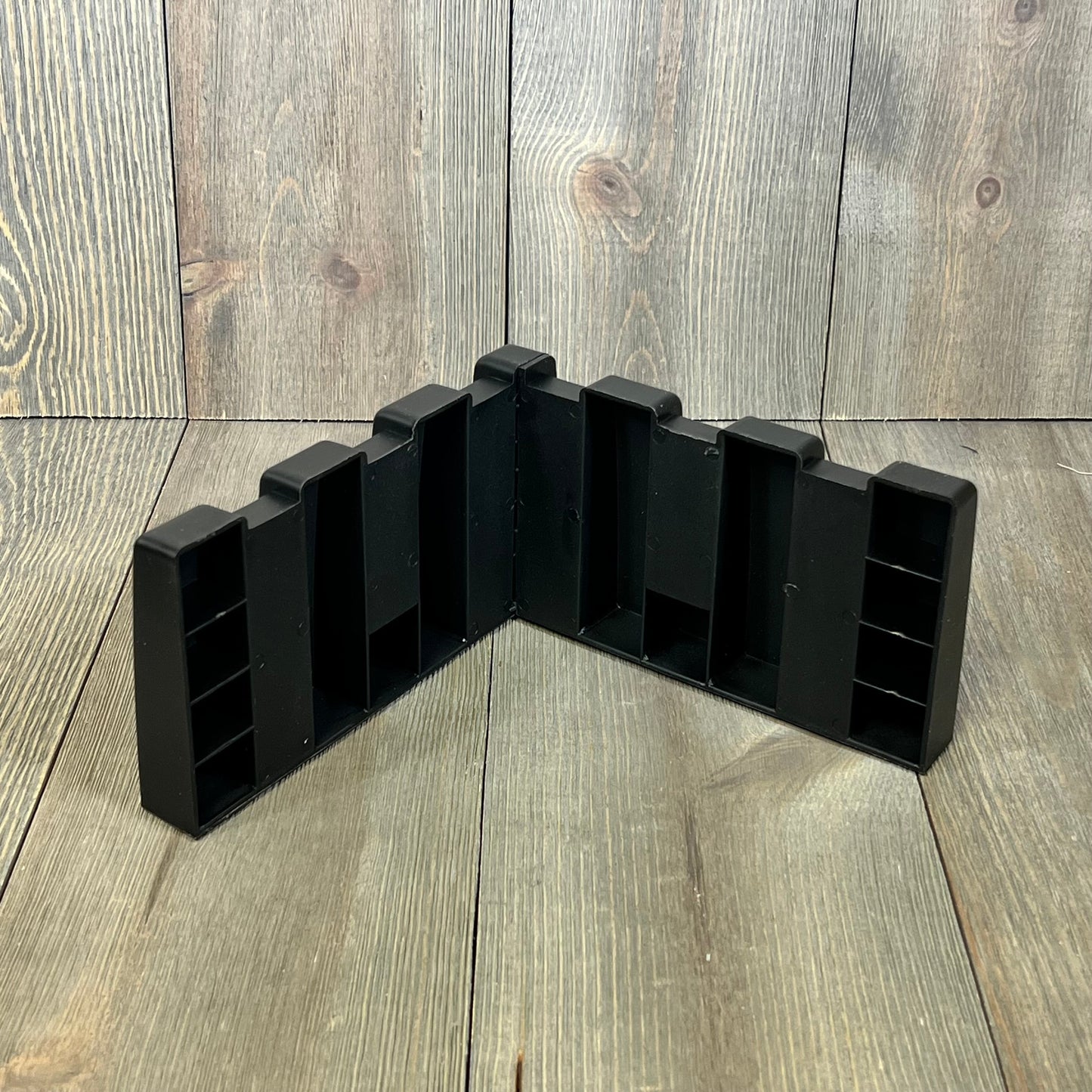Black trunk organizer block for SUVs, designed to fit wool carpet, enhances cargo storage and organization in vehicles.