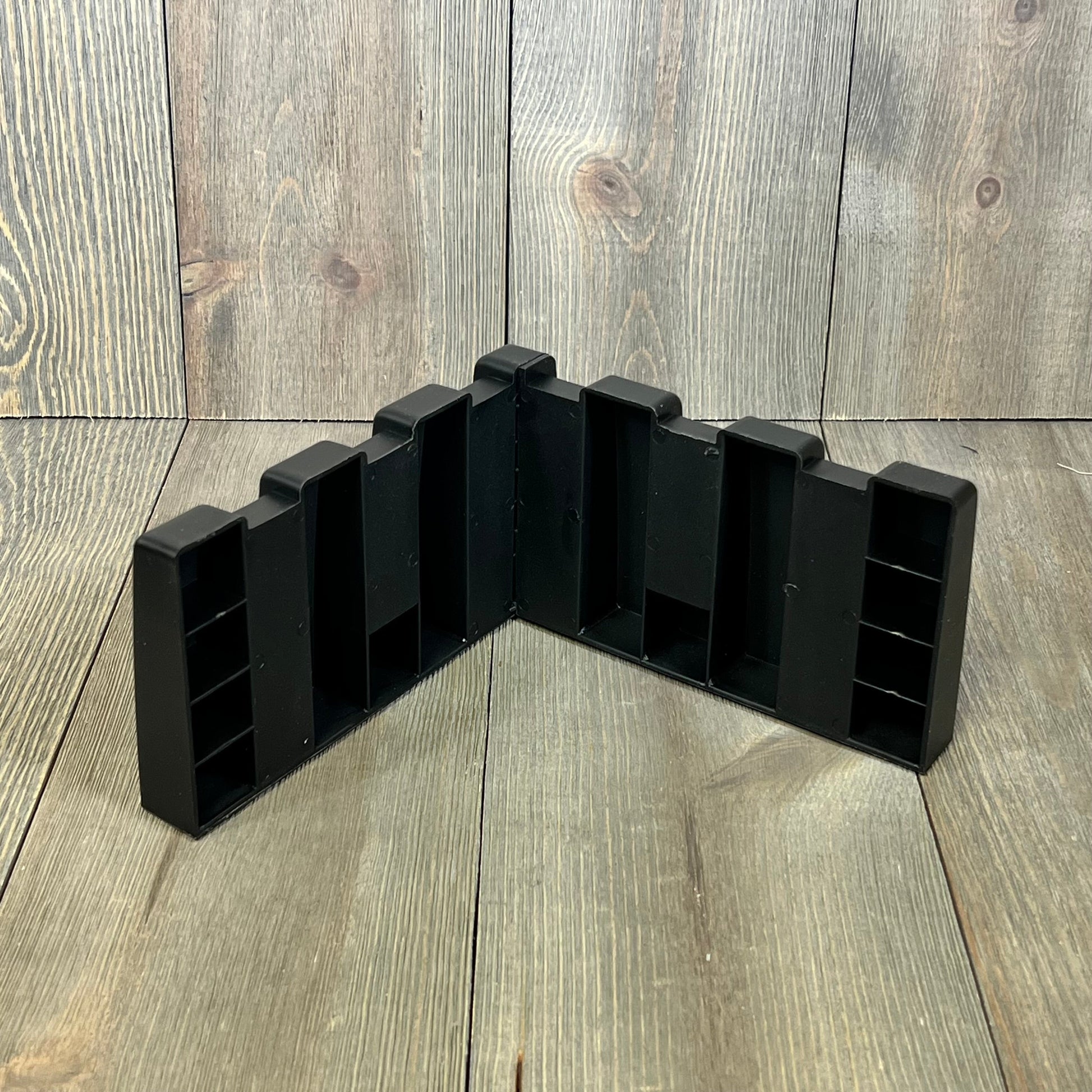 Black trunk organizer block for SUVs, designed to fit wool carpet, enhances cargo storage and organization in vehicles.
